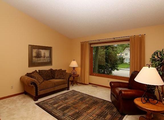 Vaulted "Great Room" features a sunken living room area with a bright sunny picture window!