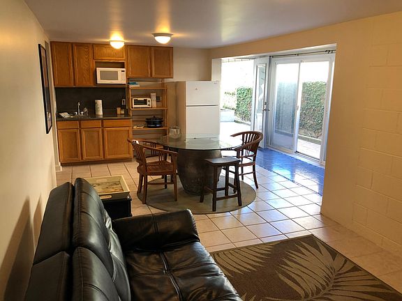 The living room, dining room and kitchen, with view of outside courtyard.