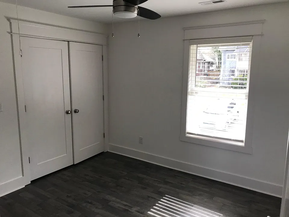 This unit is the guest (2nd) bedroom with large closet, oversized window and ceiling fan.