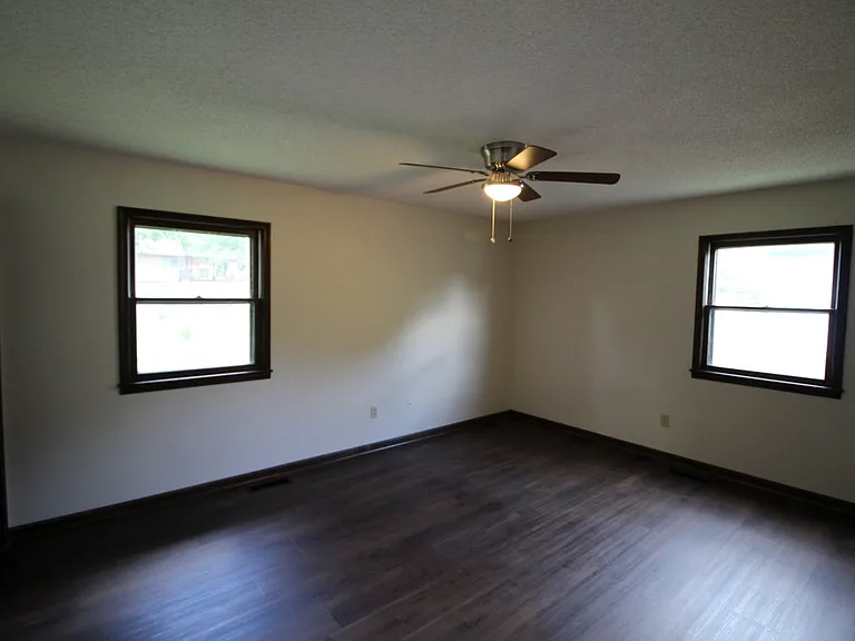 Primary bedroom with a bath and private commode area.