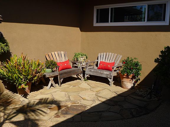 Front courtyard seating leading to front door on the right.