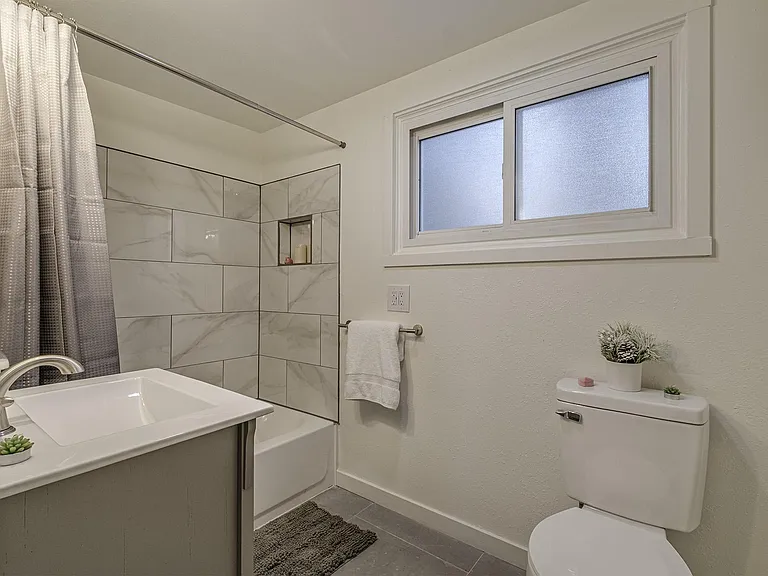 Rooms 1 and 5 share this bathroom on main floor.
