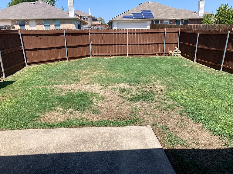 Fenced backyard and patio area off kitchen.