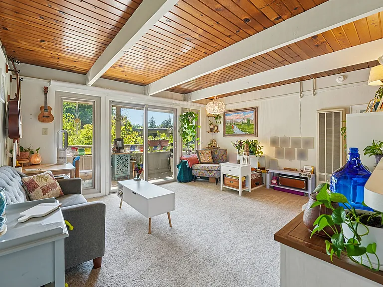 Living room in the upstairs studio, overlooking views of nature and private, covered deck.