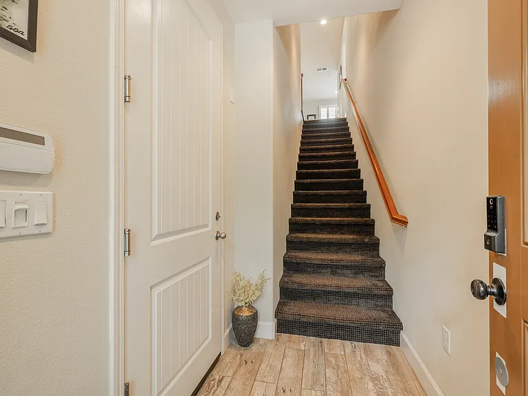 Stairs to second door and garage door on left