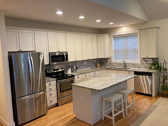 Granite countertops, stainless appliances, lots of cabinet storage and a large center island.