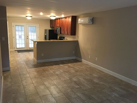 Living room looking towards kitchen. Porcelain tile everywhere except bedrooms with new LVP flooring.
