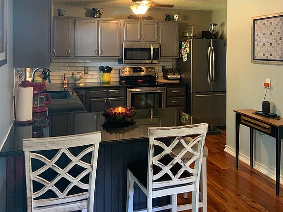 Kitchen with huge peninsula for casual dining. New Brazilian Koa hardwood floors throughout home!