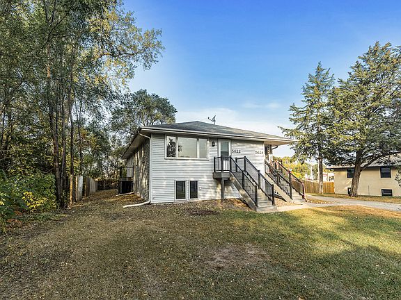 Well-maintained duplex featuring separate entries with maintenance-free stairs, large front windows, and a spacious yard, with lawn care and snow removal included for hassle-free living.