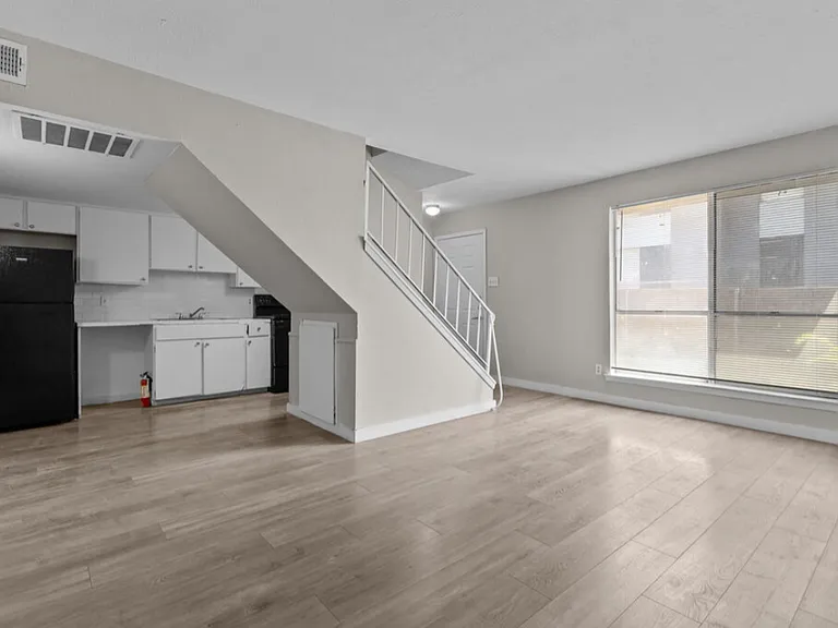 Spacious living area with modern flooring and open layout