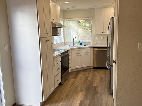 New kitchen with all new cabinets and countertop. New flooring, lights and window shades.