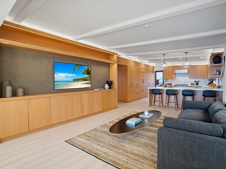 Lounge in style with custom built-ins, plush seating, and seamless flow to the kitchen.