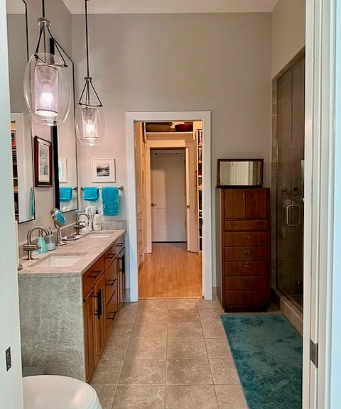 Master bath with double sink and steam shower. Adjacent to closet/dressing room.