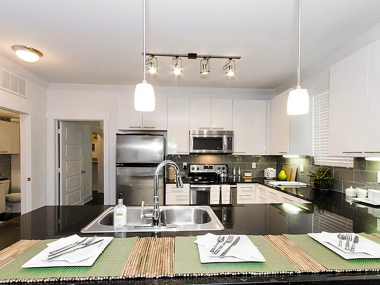 Experience culinary delights in this chic, modern kitchen equipped with state-of-the-art appliances. Experience culinary delights in this chic, modern kitchen equipped with state-of-the-art appliances.