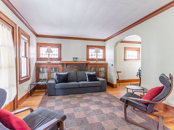 Living room view on entry from front door. Non-working fireplace. Central heat/air via floor, wall vents. Glass fronted bookcases. All furniture shown is included.