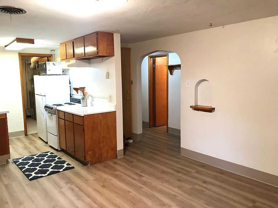 Living area, kitchen looking toward hallway to bedrooms and bath