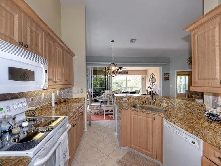 The bright, fully equipped kitchen features granite countertops, wood cabinetry, everything you need to feel at home. Enjoy open sightlines to the dining and living area, making it easy to cook, entertain, and connect with family and guests.
