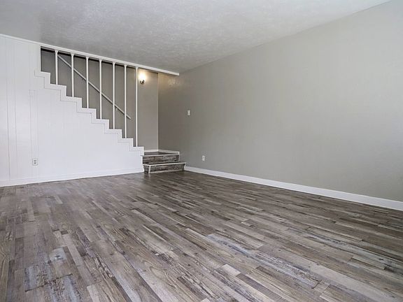Expansive living space with staircase leading to private bedrooms upstairs.