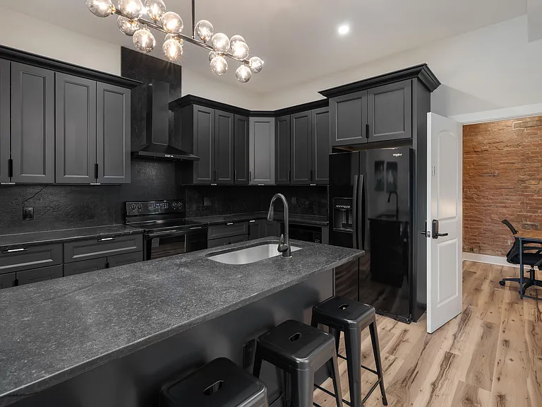 Spacious kitchen with ample cabinetry, large island with seating, and full appliance suite for everyday cooking.