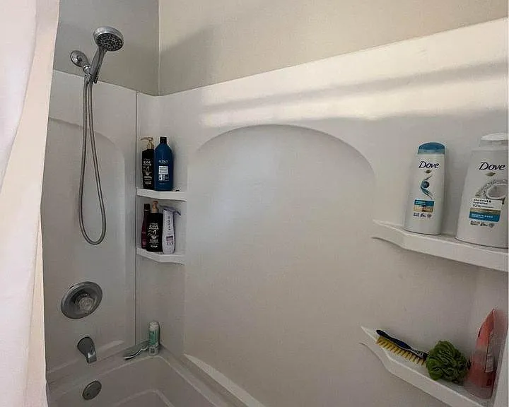 Tub and shower combo with built-in storage niche.