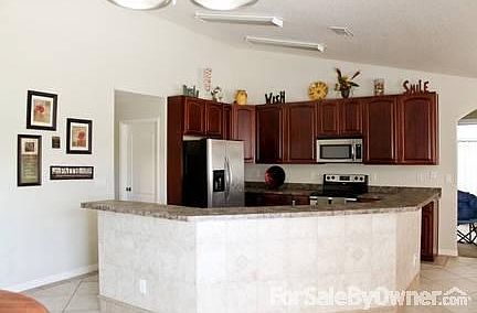 Kitchen with Elegant Tile throughout
						:
						Beautiful Cherry Cabinets. All Stainless Steel Appliances!