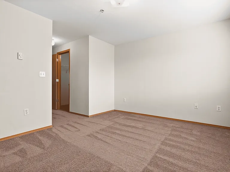 Comfortable bedroom with soft carpeting and a convenient walk-in closet. Comfortable bedroom with soft carpeting and a convenient walk-in closet.