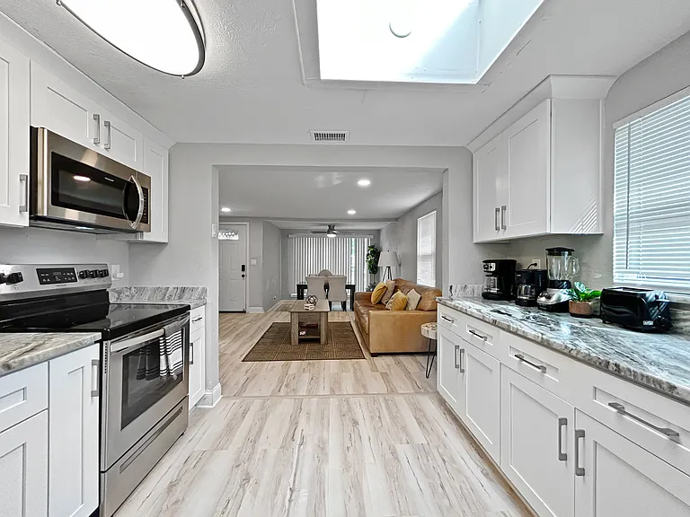 Kitchen, second angle
Ample cabinet and counter space with open sightlines to the living area. A functional, well laid out kitchen for daily use.