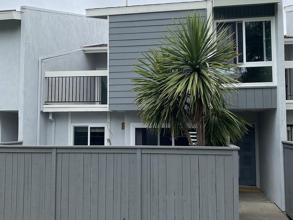 Condo Front Side also showing balcony and fence around patio area.