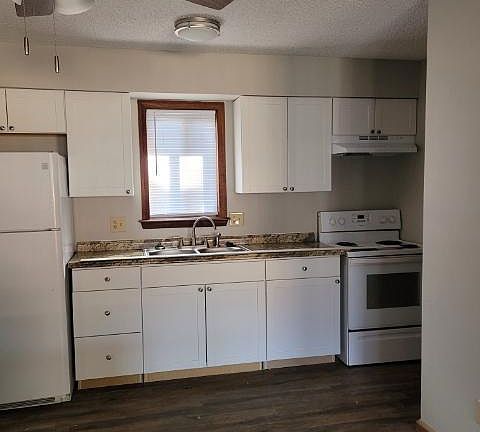 Notice new flooring and kitchen cabinets
