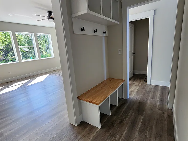 Mud room bench with butcher block seating, cubbies and coat hooks