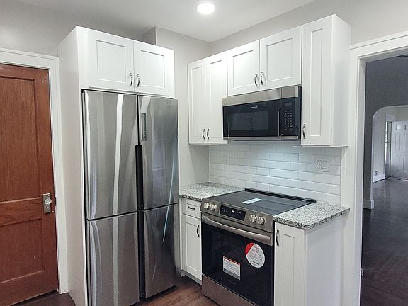 New Kitchen with new cabinets, granite countertop, stainless stove, refrigerator and Microwave.