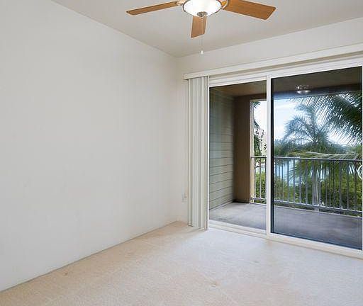 Second Bedroom with access to the Covered Lanai and beautiful Marina View and palm trees.