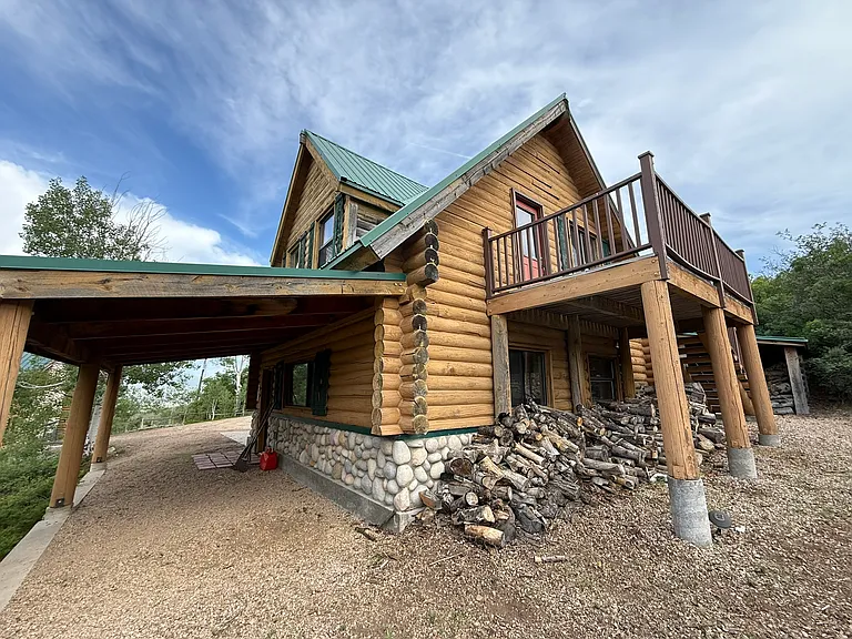 View of garage from the west, showing stairs to loft