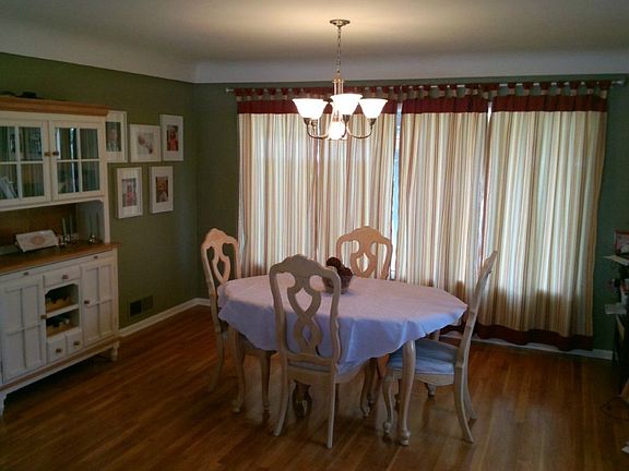 Formal dining room is large enough to house a large table plus display hutch and still not feel the least bit cramped.  The large window at this end of the room mirrors the one at the Formal living room end.  This one faces the back yard and overlooks the large covered patio and fenced yard.  