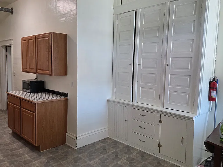 Entrance from community balcony into eat-in dining area with built in cabinet