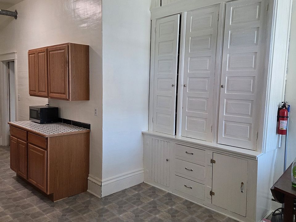 Entrance from community balcony into eat-in dining area with built in cabinet