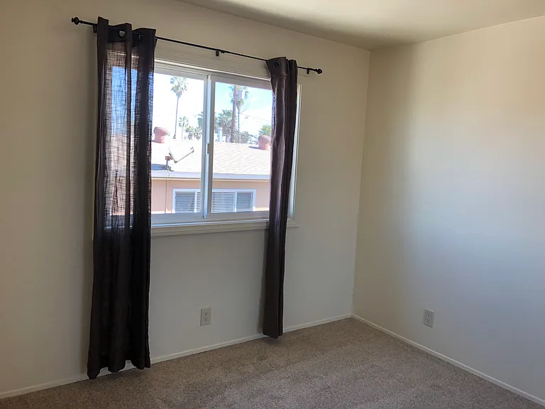 Second bedroom showing carpet and view to the north.
