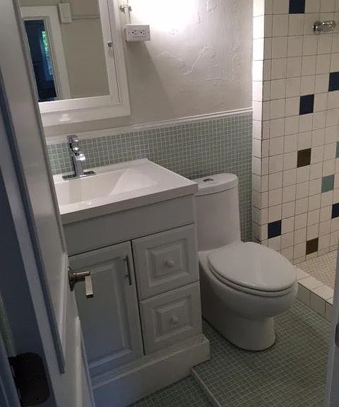 Bathroom w/ glass tile floor and walls