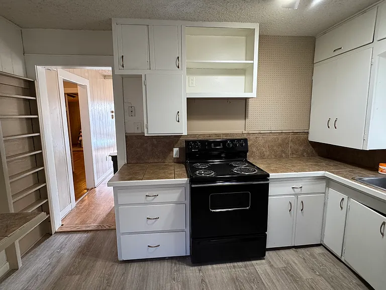 Spacious kitchen with refrigerator, electric stove, dishwasher and disposal. Good natural light