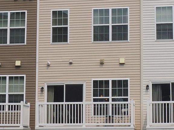 Rear of house, from alley. Trash is picked up in back, so it's easy to roll totes in and out of garage.