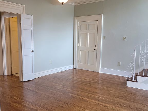 Living room. Spacious, great light, natural oak flooring. Showing front entry, entry to bedroom area and stairs to the apartment's second level