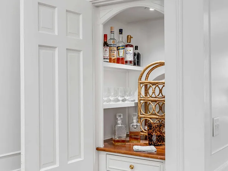 Reading room hidden bar with built in beverage fridge.