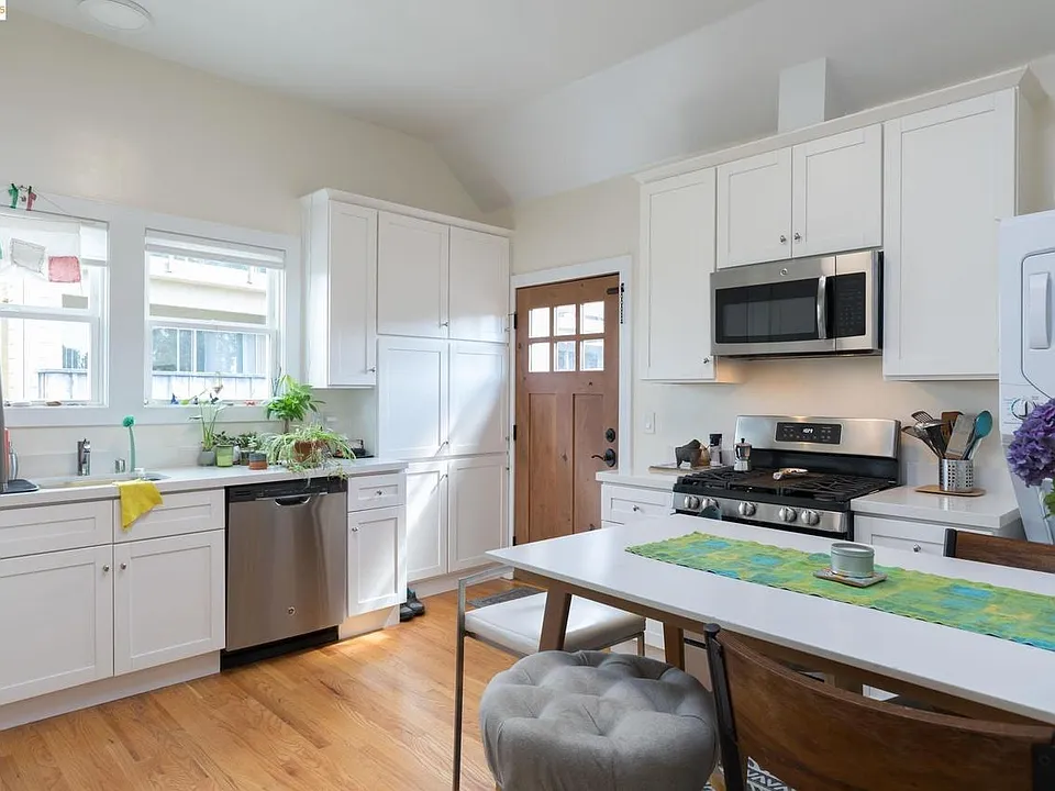 Large Kitchen with White Shaker Cabinets with Quartz Counter tops