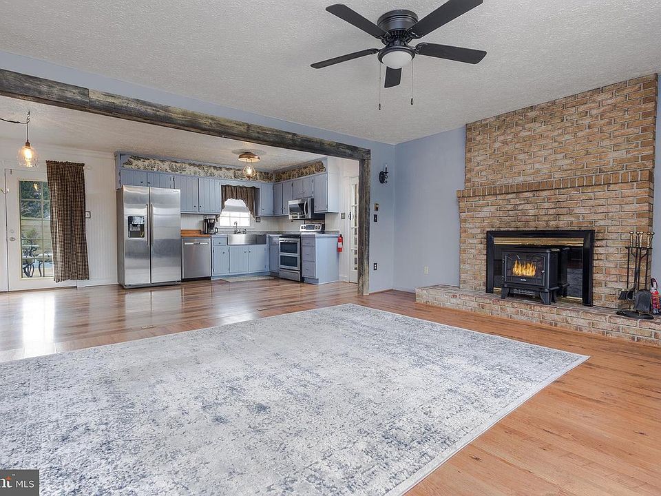 Main House Living Room Area with Wood Burning Fireplace- Open area that includes Living room, Kitchen, Dining Area is approximately 27.5 x21.5
