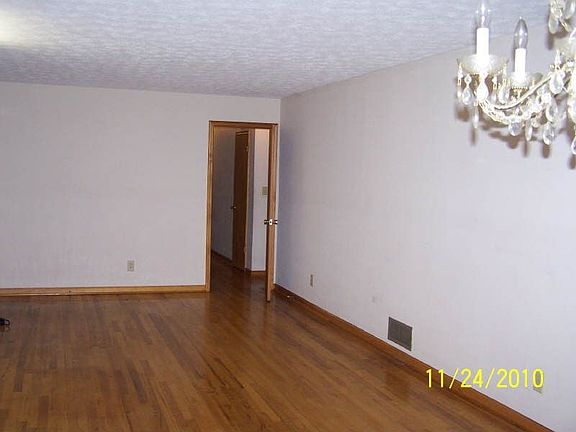view from dining area to living area-door into hallway