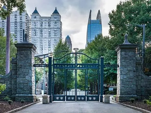 The view of The Mayfair Towers from inside the 14th Street Gates of Piedmont Park.