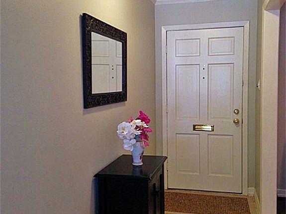 Welcome! A formal entry foyer with a travertine floor and crown molding introduces the home.