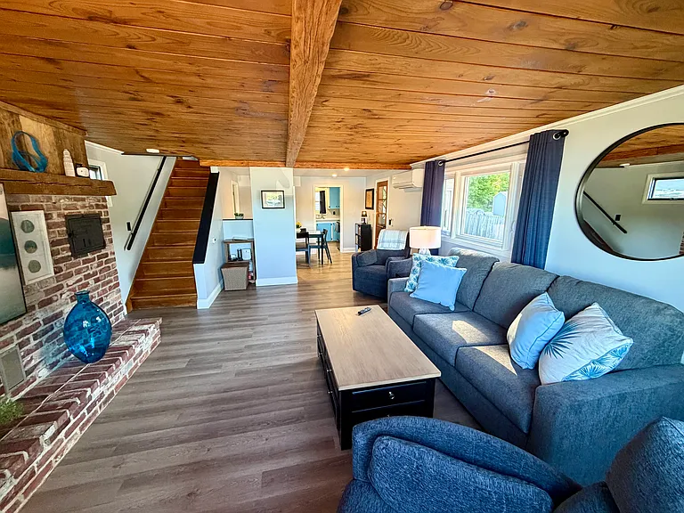 The living area adjoins the dining area and side entrance.