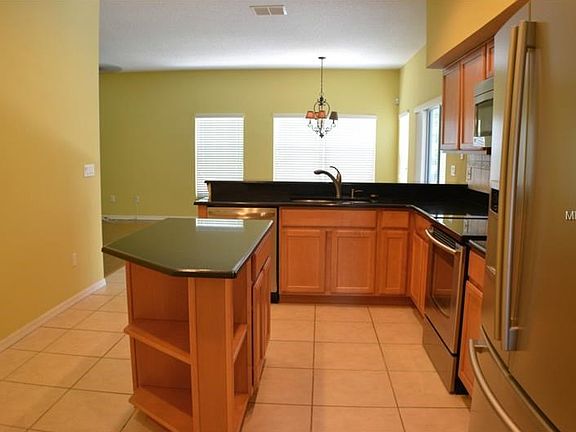 Updated Kitchen with Island storage and book case end. Looking toward breakfast room & family room.