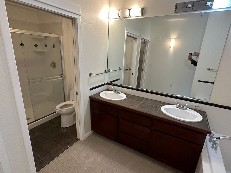 Main bathroom has twin vanities, large tub and separate shower.